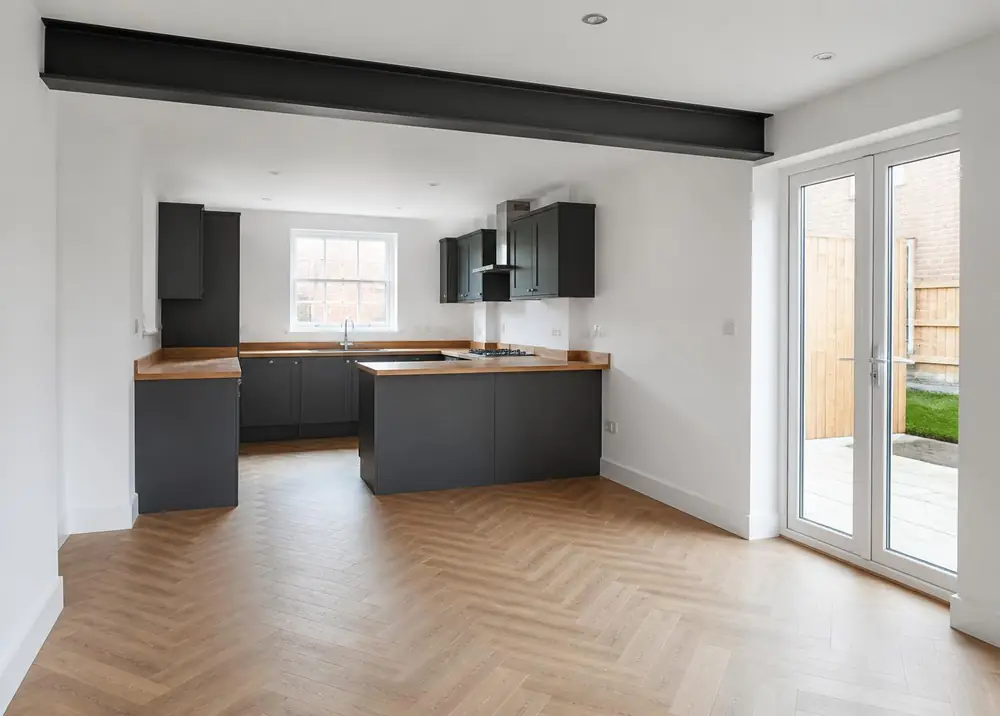Completed open plan kitchen diner with exposed steel beam in a Manchester terraced house